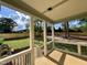 Covered outdoor porch with views of the grassy fenced backyard and clear blue skies at 217 Dublin Rd, Raleigh, NC 27609