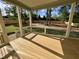 Spacious outdoor porch with wooden flooring, railing, and serene views of the fenced backyard at 217 Dublin Rd, Raleigh, NC 27609