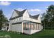 Elegant home with a screened-in porch, expansive windows, and lush greenery at 217 Dublin Rd, Raleigh, NC 27609