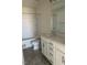 Bathroom featuring white cabinets, bathtub and shower, large mirror, and grey tile flooring at 253 Plains Dr # 264, Burlington, NC 27217