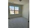 Cozy bedroom featuring a large window, neutral carpet, and ample natural light at 253 Plains Dr # 264, Burlington, NC 27217