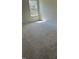 Bright bedroom with plush neutral carpet and a window offering natural light at 253 Plains Dr # 264, Burlington, NC 27217