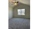Bedroom featuring neutral carpet, ceiling fan, vaulted ceiling and a view of the neighborhood at 253 Plains Dr # 264, Burlington, NC 27217