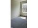 Well-lit bedroom with neutral carpet and a view from the window at 253 Plains Dr # 264, Burlington, NC 27217