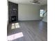 Spacious living room with wood floors, stacked stone fireplace, ceiling fan, and natural light at 253 Plains Dr # 264, Burlington, NC 27217