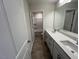 A bathroom featuring a double sink vanity with a large mirror and a separate toilet area at 120 Wild Turkey Way, Lillington, NC 27546