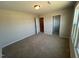 Bedroom featuring carpeted floors, a closet, and ample natural light from the window at 120 Wild Turkey Way, Lillington, NC 27546