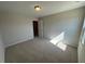 A well-lit, carpeted bedroom with a neutral color scheme and a doorway in the background at 120 Wild Turkey Way, Lillington, NC 27546