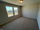 Bright bedroom featuring carpeted floors and two windows offering a pleasant view at 120 Wild Turkey Way, Lillington, NC 27546