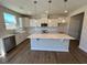 Modern kitchen featuring stainless steel appliances and a spacious center island at 120 Wild Turkey Way, Lillington, NC 27546