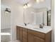Double vanity bathroom with large mirror and adjacent bedroom at 211 Wild Turkey Way, Lillington, NC 27546