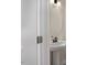 Powder room with pedestal sink and round mirror at 211 Wild Turkey Way, Lillington, NC 27546