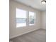 Bright bedroom with carpet flooring and two large windows at 211 Wild Turkey Way, Lillington, NC 27546