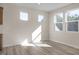 Well-lit bedroom with hardwood floors and multiple windows at 211 Wild Turkey Way, Lillington, NC 27546