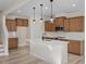 Modern kitchen with an island and light wood cabinets at 211 Wild Turkey Way, Lillington, NC 27546