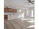 Open kitchen with island, hardwood floors, and modern appliances at 211 Wild Turkey Way, Lillington, NC 27546