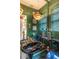 Stylish bathroom with green wallpaper, unique light fixtures, and a black vanity with sink at 2501 Kenmore Dr, Raleigh, NC 27608
