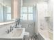 Elegant bathroom featuring marble countertops, tiled shower, and patterned tile flooring at 2501 Kenmore Dr, Raleigh, NC 27608