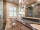 Bathroom featuring a double vanity with granite countertop, a soaking tub, and mirrored cabinetry at 2501 Kenmore Dr, Raleigh, NC 27608