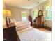 Cozy bedroom featuring hardwood floors, lots of natural light, and vintage furnishings at 2501 Kenmore Dr, Raleigh, NC 27608