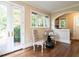 Charming breakfast nook with hardwood floors, arched doorway, and views of the backyard at 2501 Kenmore Dr, Raleigh, NC 27608