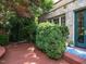 A cozy deck area with vibrant plants, complementing the home's stone exterior and blue accents at 2501 Kenmore Dr, Raleigh, NC 27608