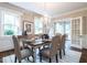 Elegant dining room with crystal chandelier, large windows, and access to an adjacent sunroom at 2501 Kenmore Dr, Raleigh, NC 27608