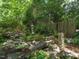 Zen garden featuring a stone lantern and lush greenery, creating a peaceful and serene outdoor retreat at 2501 Kenmore Dr, Raleigh, NC 27608