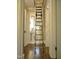 Hallway with pull-down stairs leading to the attic and a full view of the bathroom at 2501 Kenmore Dr, Raleigh, NC 27608