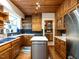 Well-lit kitchen featuring a stainless steel island, and ample wooden cabinetry at 2501 Kenmore Dr, Raleigh, NC 27608