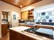 Cozy kitchen featuring wood cabinets, a gas range cooktop, and unique backsplash tile details at 2501 Kenmore Dr, Raleigh, NC 27608