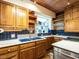 Updated kitchen with wooden cabinets, white countertops, blue tile backsplash, and stainless appliances at 2501 Kenmore Dr, Raleigh, NC 27608