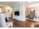 Open concept living area with built-in shelving, hardwood floors and view of dining room at 2501 Kenmore Dr, Raleigh, NC 27608