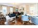 Bright living room showcases hardwood floors, fireplace, chandelier, and an array of furniture at 2501 Kenmore Dr, Raleigh, NC 27608