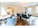 Spacious living area features hardwood floors, chandelier, and windows providing ample natural light at 2501 Kenmore Dr, Raleigh, NC 27608