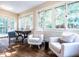 Bright sunroom with an abundance of windows, hardwood floors, and comfortable seating at 2501 Kenmore Dr, Raleigh, NC 27608