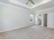 Large main bedroom featuring carpet, ceiling fan and tray ceiling at 67 Decatur Dr, Fuquay Varina, NC 27526