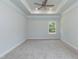 Large main bedroom featuring carpet, ceiling fan and tray ceiling at 67 Decatur Dr, Fuquay Varina, NC 27526