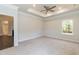 Large main bedroom featuring carpet, ceiling fan and tray ceiling at 67 Decatur Dr, Fuquay Varina, NC 27526