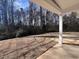 A covered back patio looks out onto the lawn and trees of the spacious backyard at 3113 Petrea Ct # 38, Angier, NC 27501