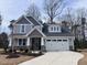 Charming two-story home with stone accents, neutral siding, attached two car garage and landscaped yard at 3113 Petrea Ct # 38, Angier, NC 27501