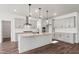 This spacious, modern kitchen boasts gray cabinetry, stainless appliances, granite countertops and hardwood floors at 3113 Petrea Ct # 38, Angier, NC 27501