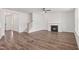 Bright living room featuring a fireplace, wood floors, stairway to second floor and large windows at 3113 Petrea Ct # 38, Angier, NC 27501