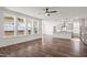 Open-concept living area and kitchen featuring hardwood floors and abundant natural light streaming through large windows at 3113 Petrea Ct # 38, Angier, NC 27501