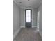 An empty room featuring white trim, light gray walls, and a door with glass panels at 3113 Petrea Ct # 38, Angier, NC 27501