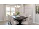 Elegant dining room with a dark wood table, chandelier, and neutral decor at 22 Capeside Ct, Lillington, NC 27546