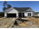 Newly constructed home with white siding, stone accents, and a two-car garage at 40 Capeside Ct, Lillington, NC 27546