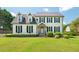 Charming two-story home featuring a manicured lawn, dormer windows, and black shutter accents at 135 Deep Creek, Rougemont, NC 27572