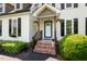 Inviting front porch with brick steps and decorative flower baskets at 135 Deep Creek, Rougemont, NC 27572