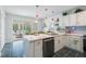 Well-lit kitchen with stainless steel appliances and counter seating overlooking the patio at 135 Deep Creek, Rougemont, NC 27572